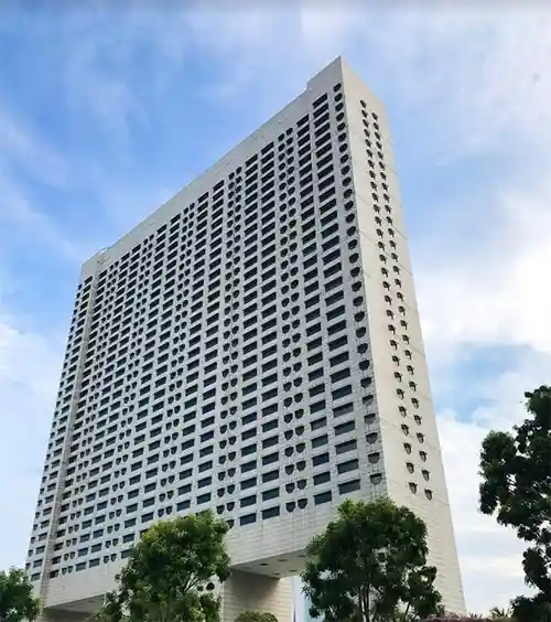 Exterior view of Ritz Carlton Singapore showing its octagonal windows and elevated base